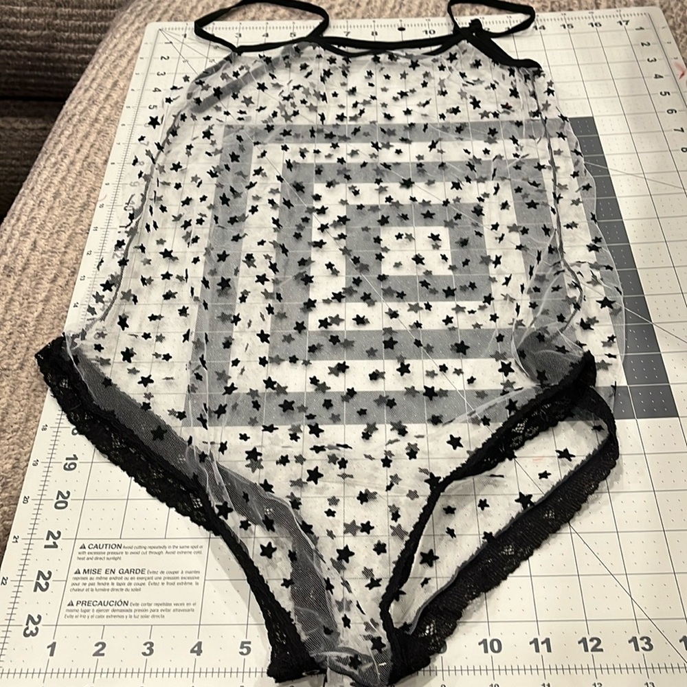 Sheer bodysuit with black stars. Unbranded. Sold as one size fits all.
